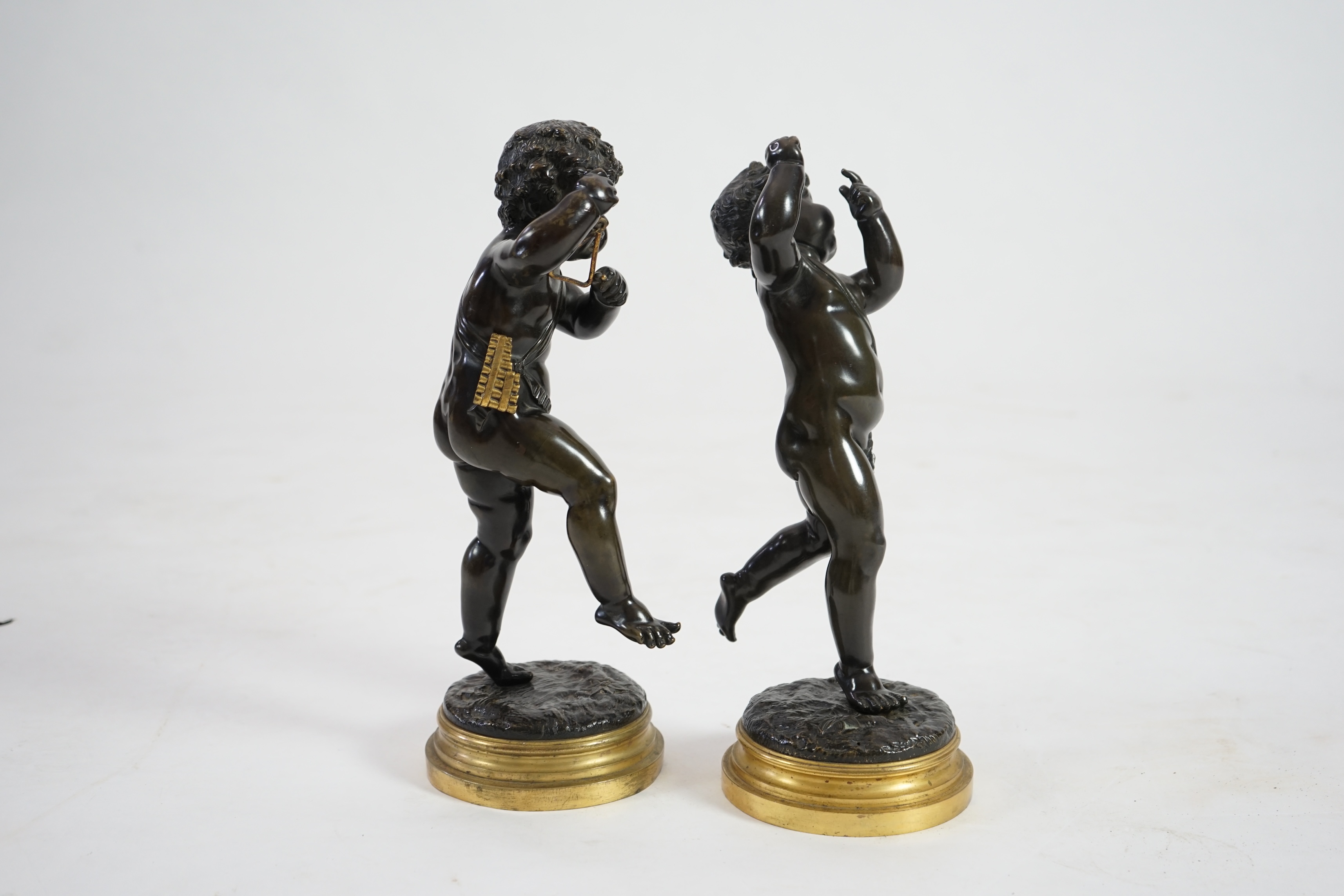 After Claude Michel Clodion (French, 1738-1814), a pair of late 19th century bronze figures of musical putti